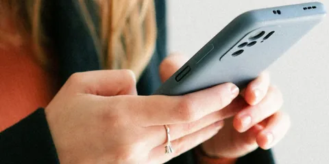 A customer looking at a business website on her phone