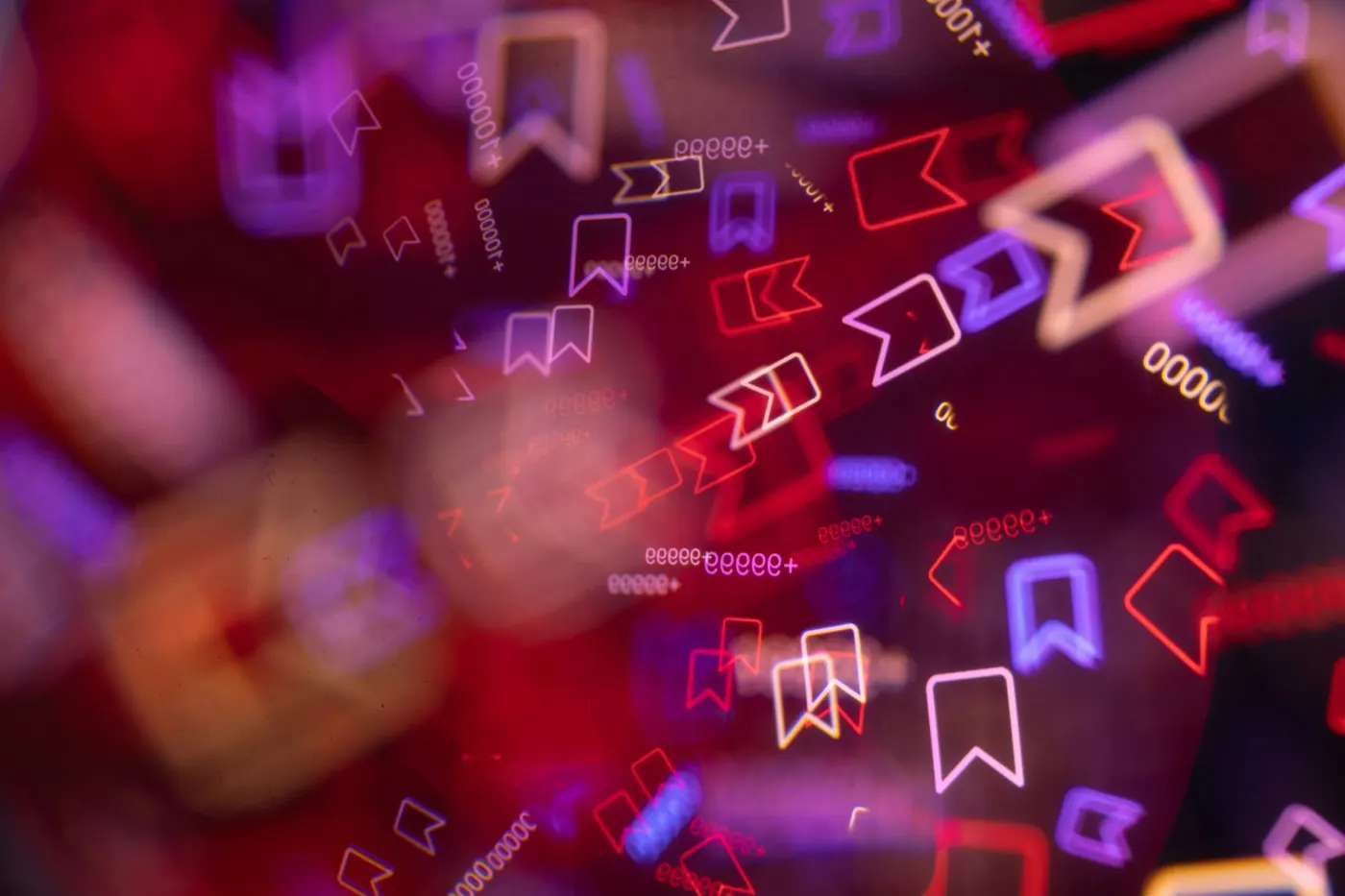 Neon save and bookmark icons blurred in red and purple light