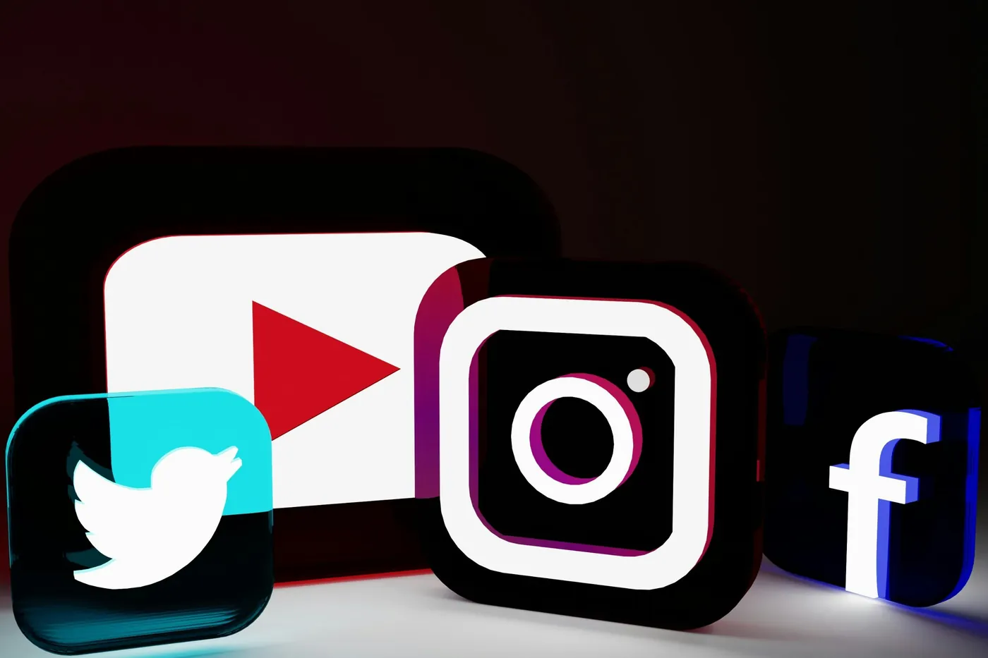 Three-dimensional social media icons on a dark background